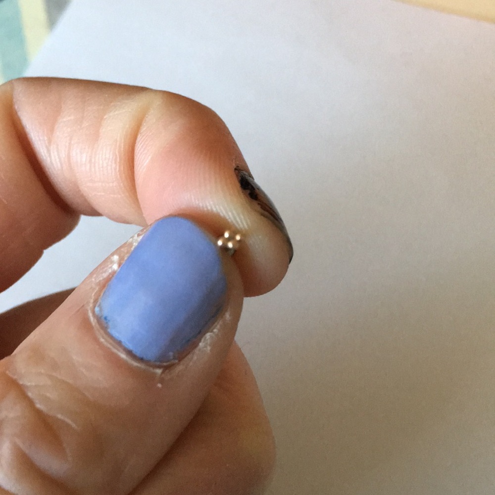 Dainty gold earring.